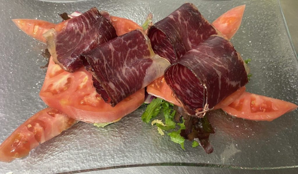 Carne y tomate en plato